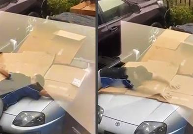 Видео: Со сопственото тело го штити автомобилот од град