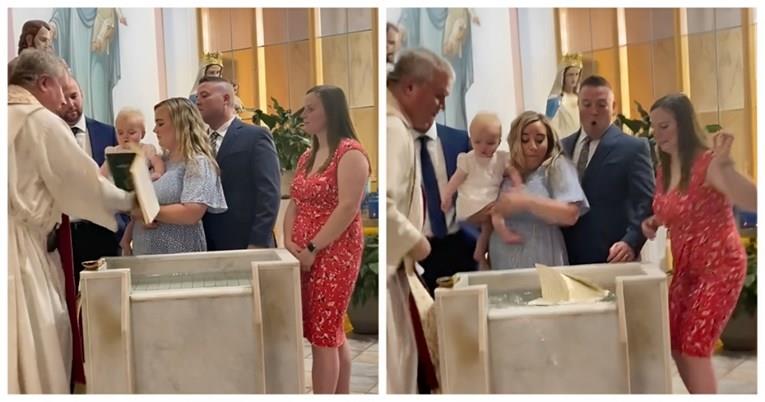 Бебе стана хит на социјалните мрежи- додека го крстеа, му ја турна Библијата на попот (ВИДЕО)